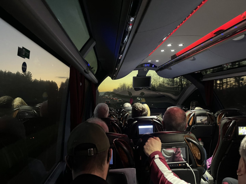 View south along the A38 at sunset, from inside a coach with panoramic window arrangement