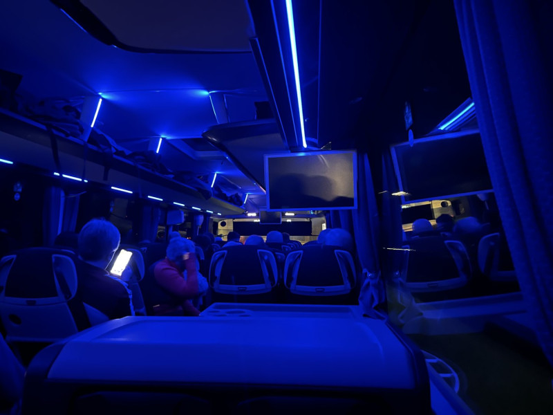 Internal view of a coach, travelling on the motorway, at night